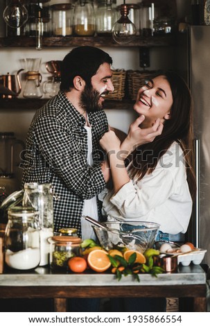 Sweet family couple having fun during cooking together Royalty-Free Stock Photo #1935866554