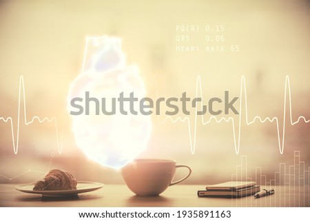 Double exposure of heart drawing hologram over coffee cup background in office. Concept medical education.