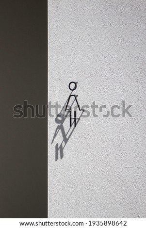 Modern sign shadow of outdoor toilet