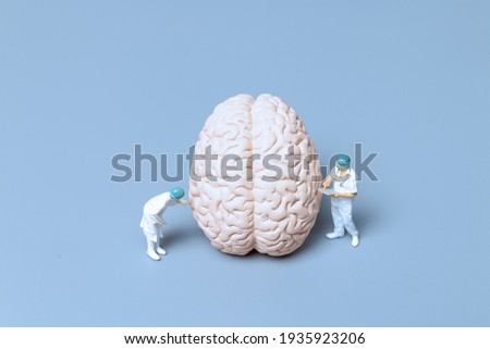Miniature Doctor checking and analysis alzheimer's disease and dementia of brain, Science and medicine concept Royalty-Free Stock Photo #1935923206