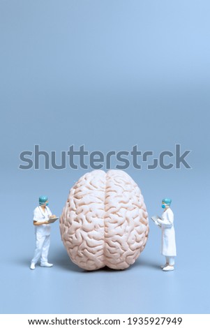 Miniature Doctor checking and analysis alzheimer's disease and dementia of brain, Science and medicine concept Royalty-Free Stock Photo #1935927949