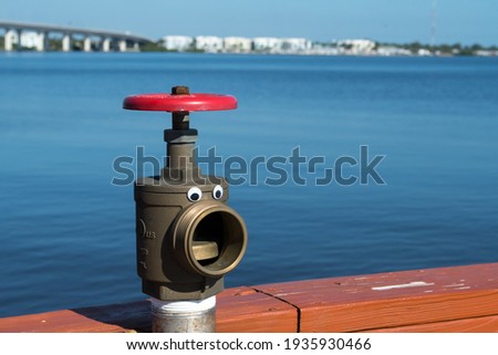 Fun faucet and valve on the pier in Historic Downtown Stuart, Florida, with waterfront parks, St. Lucie River
