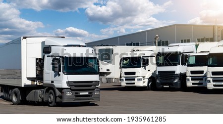 Semi trucks are parked in a row Royalty-Free Stock Photo #1935961285