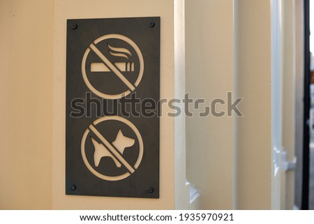Black prohibition signs on white background. No smoking, no dog allowed.