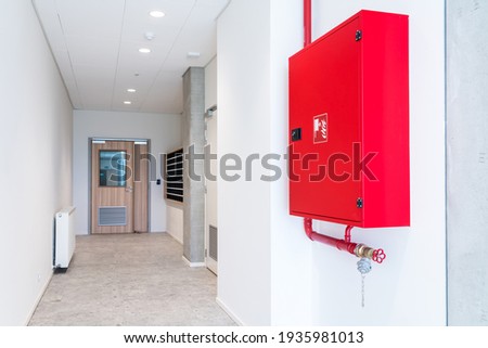 an fire hose hanging on the wall in an room