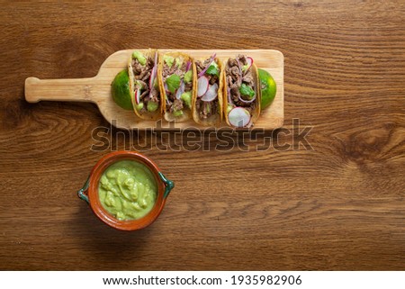 top view of Mexican tacos with guacamole and onion. gourmet mexican food