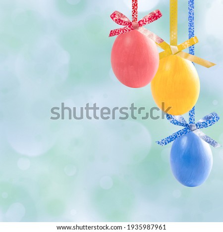 Holiday card with colorful easter eggs hang on ribbon and place for your text