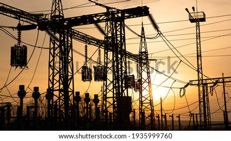 silhouette of a electrical sub station, Energy and industry. distribution electric substation with power lines and transformers, at sunset Royalty-Free Stock Photo #1935999760