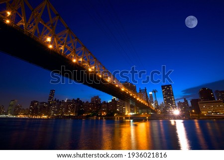 Sunset view of Manhattan skyline with Queensboro Bridge over East River