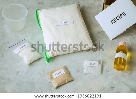 A set of ingredients for baking home made bread: wholemeal flour, salt, sugar, sunflower or olive oil, yeast
