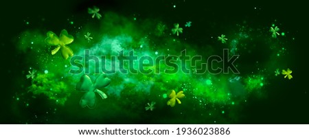 St. Patrick's Day abstract green background decorated with shamrock leaves. Patrick Day pub party celebrating. Abstract Beer art design magic backdrop. Widescreen clovers on black with copy space
