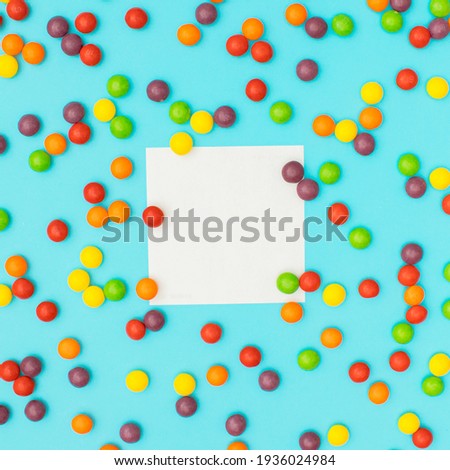 Small colorful balls around the copy space on blue background. Love background flat lay concept.