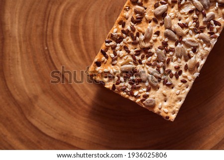 Flour breadcrumbs biscuits with sunflower flax seeds on awooden background. Top view. High quality photo