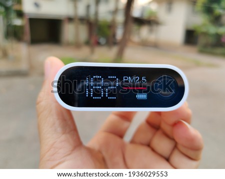 Close up of portable air quality monitor detect PM 2.5 with high level is polluted air quality.
 Royalty-Free Stock Photo #1936029553