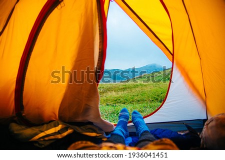 Feet woman relaxing enjoying vacation veiw from tent camping Travel lifestyle concept beautiful mountains landscape. High quality photo