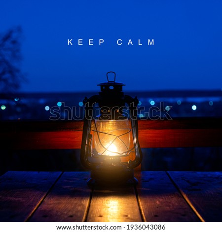 Keep calm background. Relaxing background with ancient kerosene lamp on the table and text keep calm. Square photography. 