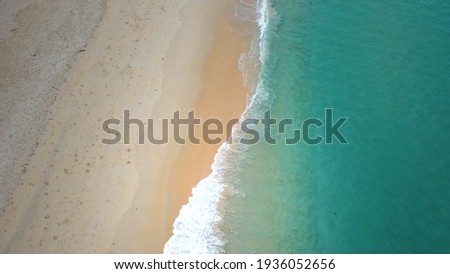 Soft wave and beautiful sand beach aerial view drone shot on a Surin beach, Phuket Thailand.