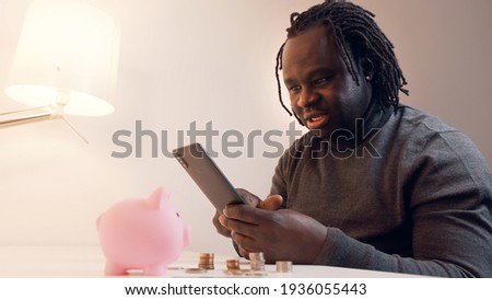 Online shopping, Young african american black man using smartphone for online shopping and paying with credit card. High quality photo