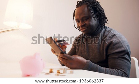 Online shopping, Happy young man using smartphone for online shopping and paying with credit card. High quality photo