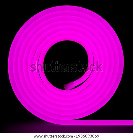 Purple flexible glowing led tape neon in reel standing on black background.