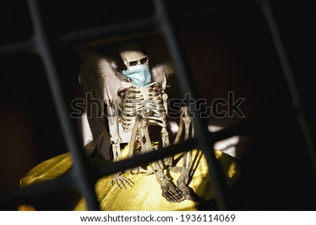 Сoronavirus skeleton in medical mask.