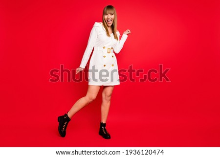 Full length photo of young attractive excited woman happy positive smile isolated over red color background