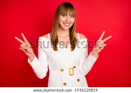 Photo of young woman cheerful happy positive smile show peace cool v-sign isolated over red color background