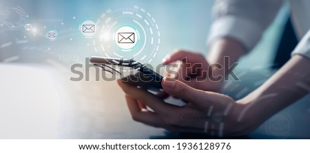 Woman hand holding smartphone and show email screen on application mobile in the office.