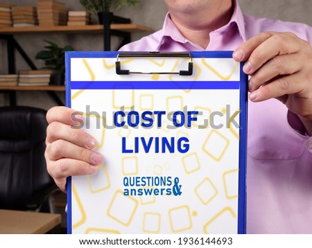 Business concept meaning COST OF LIVING with phrase on the sheet. 
