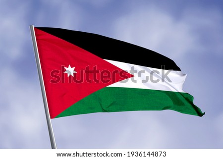 Jordan flag isolated on sky background. close up waving flag of Jordan. flag symbols of Jordan. Royalty-Free Stock Photo #1936144873