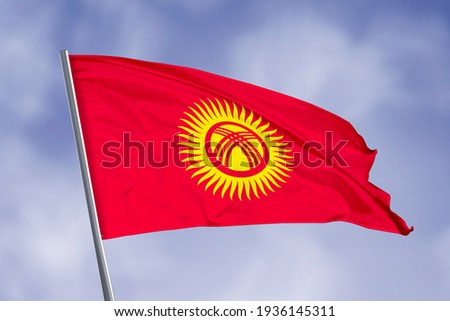 Kyrgyzstan flag isolated on sky background. close up waving flag of Kyrgyzstan. flag symbols of Kyrgyzstan.
