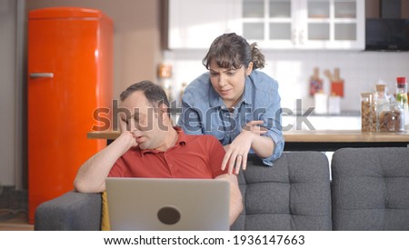 Young couple is shopping online from the computer. A young couple browsing online shopping sites looking for products. Online shopping concept.  Royalty-Free Stock Photo #1936147663
