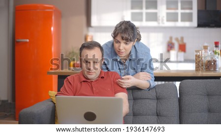 Young couple is shopping online from the computer. A young couple browsing online shopping sites looking for products. Online shopping concept.  Royalty-Free Stock Photo #1936147693