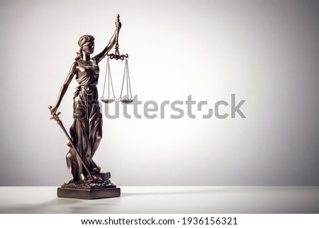 Legal law concept statue of Lady Justice with scales of justice background Royalty-Free Stock Photo #1936156321