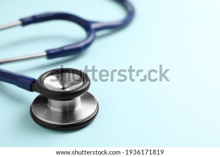 Stethoscope on light blue background, closeup. Space for text Royalty-Free Stock Photo #1936171819