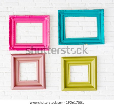 four photo frames on the white wall