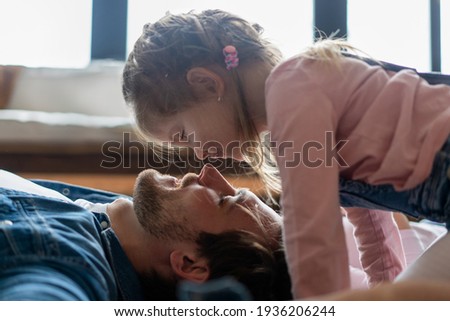 happy family and father's day. child daughter kissing and hugging dad.