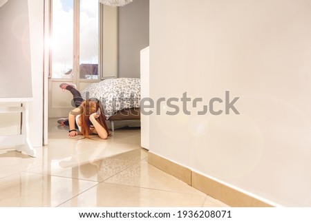 Attractive red hair sportswoman training in her beautiful house doing abdominals - Ginger athletic model exercising next to her bed during quarantine