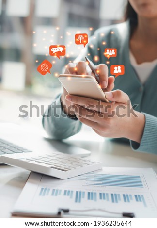 Young woman's hand is using a smartphone to play social media, a mobile phone with a notification icon,Social Distancing ,Working From Home concept.