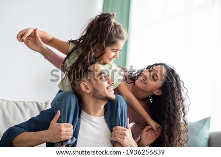 Cheerful Middle Eastern Family Of Three Having Fun Together At Home Royalty-Free Stock Photo #1936256839