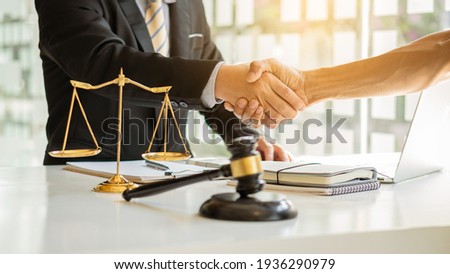 Male attorney advisor or judge advisor concept, having team meetings with clients, legal concepts and hammer attorneys with fair scales on desks in the office.