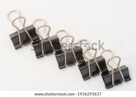 Closeup of several paper clips in different positions and arranged randomly.