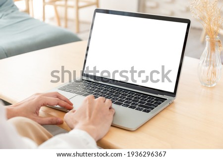computer screen blank mockup.hand woman work using laptop with white background for advertising,contact business search information on desk at coffee shop.marketing and creative design Royalty-Free Stock Photo #1936296367