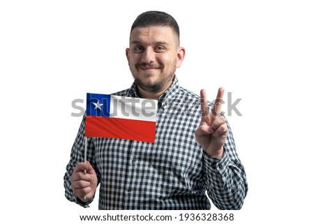 White guy holding a flag of Chile and shows two fingers isolated on a white background.