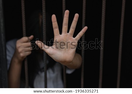 Girl stressed trapped in steel cage.The concept of violence against woman. Royalty-Free Stock Photo #1936335271
