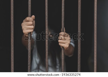 Girl stressed trapped in steel cage.The concept of violence against woman. Royalty-Free Stock Photo #1936335274