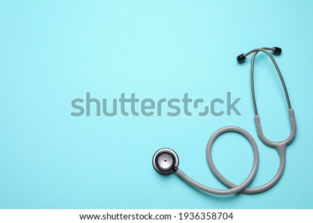 Stethoscope on light background, top view. Space for text Royalty-Free Stock Photo #1936358704