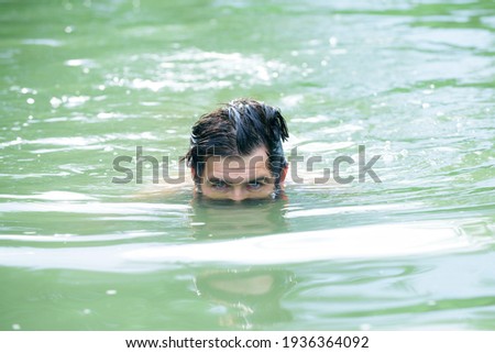 Man swimming in water. Summertime vacation weekend