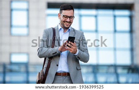 Young businessman on the way to the office searching information on the internet with smartphone. Business, education, lifestyle concept Royalty-Free Stock Photo #1936399525