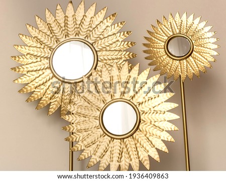 Decor round mirror with gold petals. Fashionable home decor. Three mirrors.
